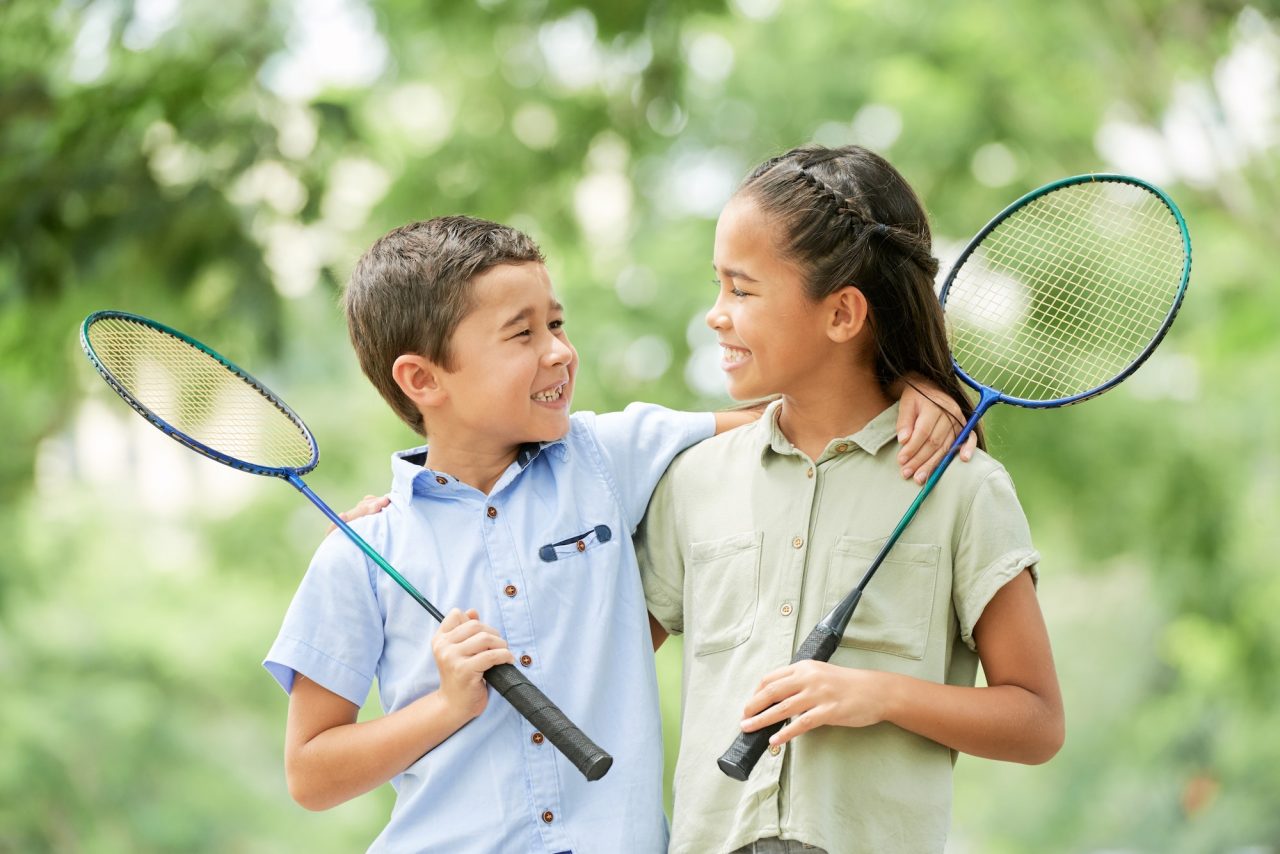 Cheerful siblings after badminton game