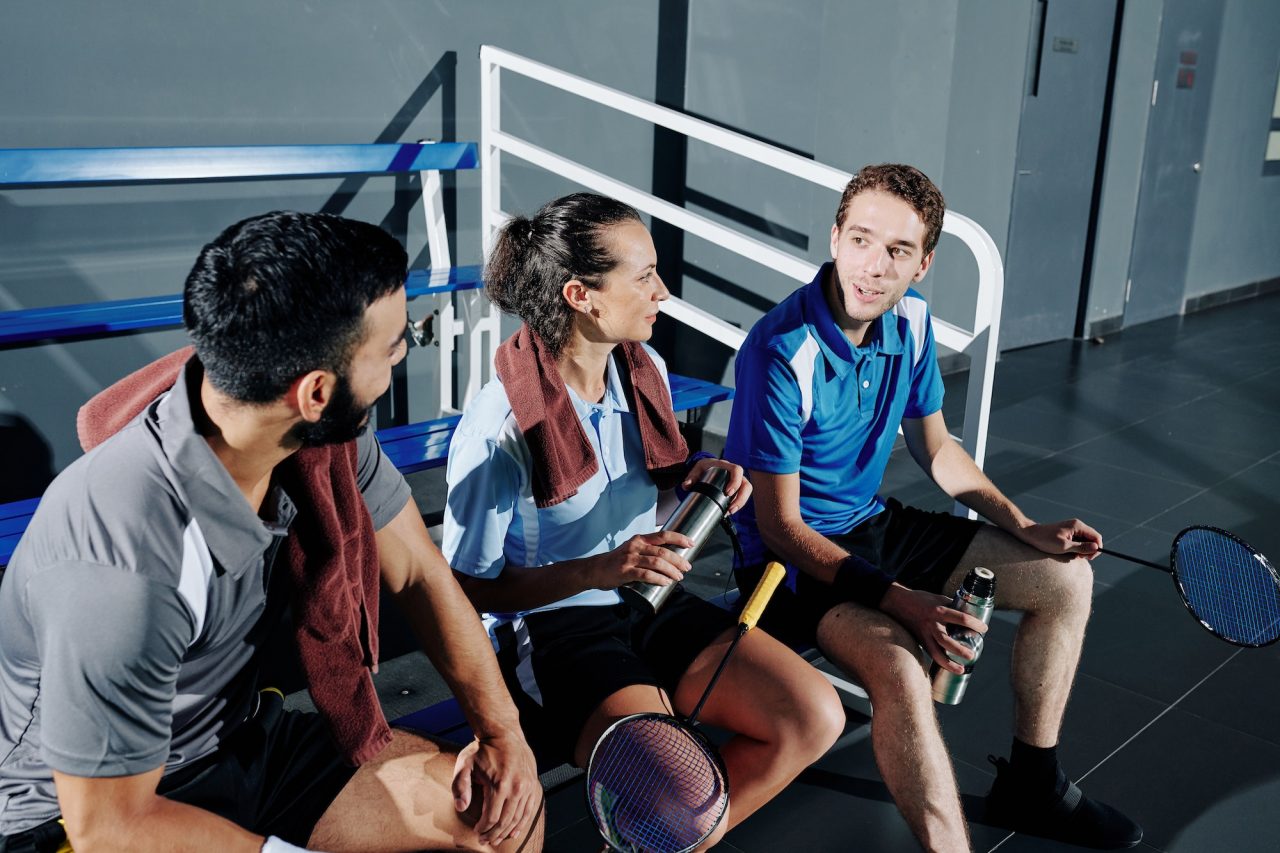 Badminton players resting on bench