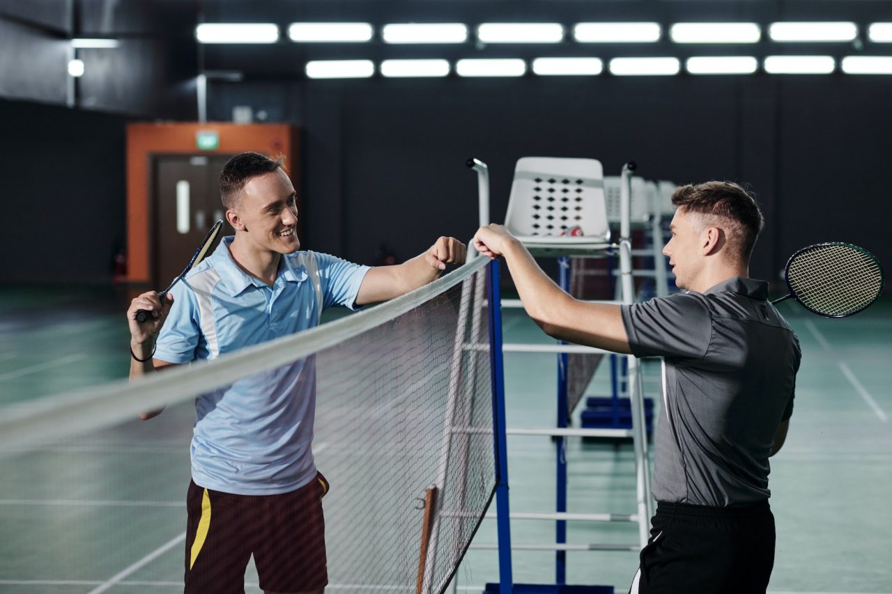  Badminton Players Making Fist Bump Gesture